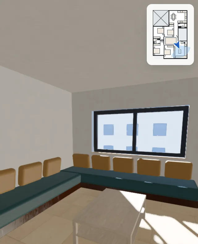 Dans la maison exemple à hauteur d’yeux : le salon avec ses banquettes et sa table au soleil de l’après-midi, la fenêtre, et le petit plan dans le coin.